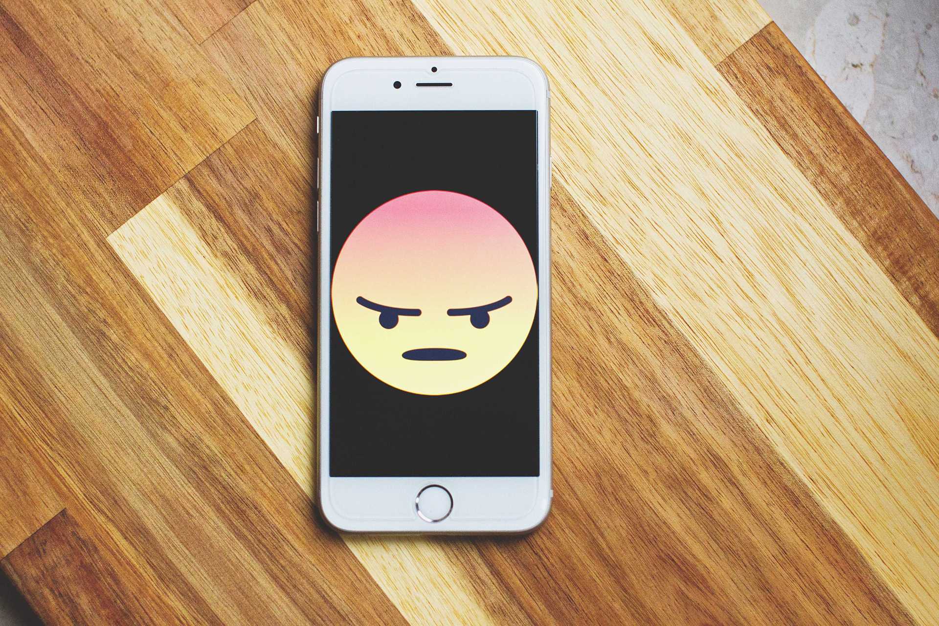 angry face on cellular phone handset